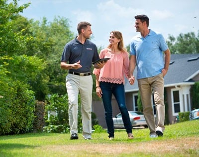 Generac dealer discussing generator installation with some homeowners