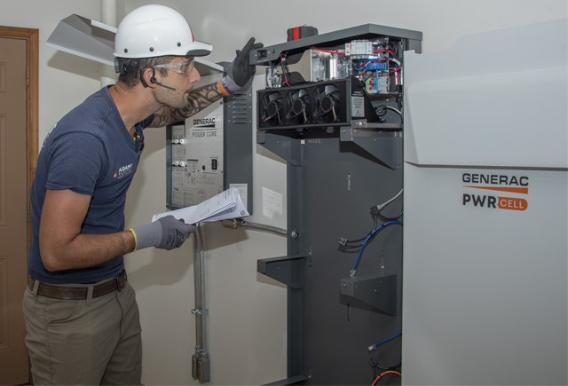 Worker installing a Generac PWRCell transfer switch